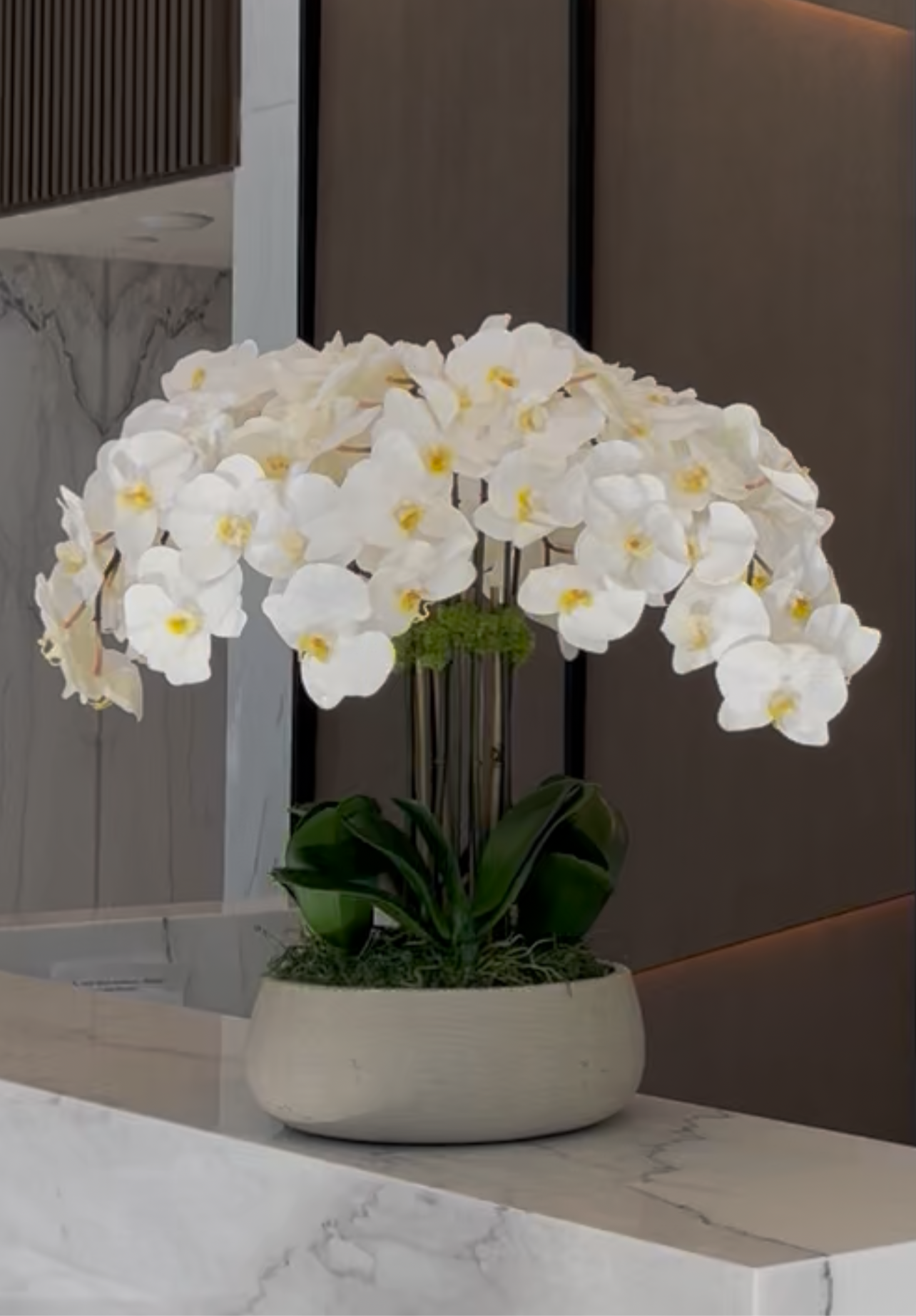 Faux White Orchid Flower Composition in Ceramic Vase and Natural Moss